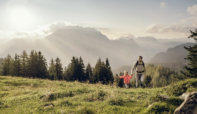 Father and daughter hiking in fields